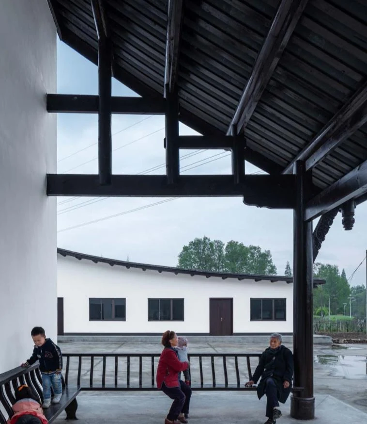 People using the timber veranda at the renewed Nanxi Yao school